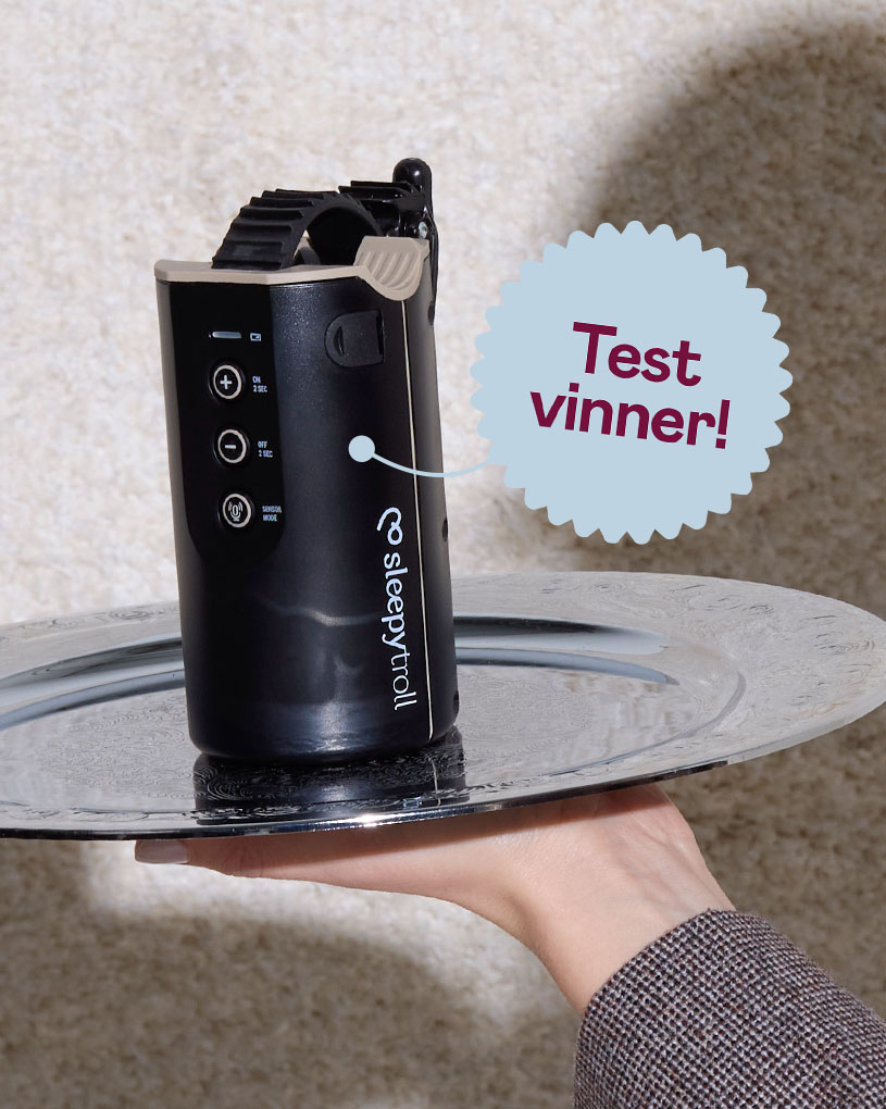 En hånd holder et sølvfat med en svart enhet fra Sleepytroll, med teksten 'Best i test'.